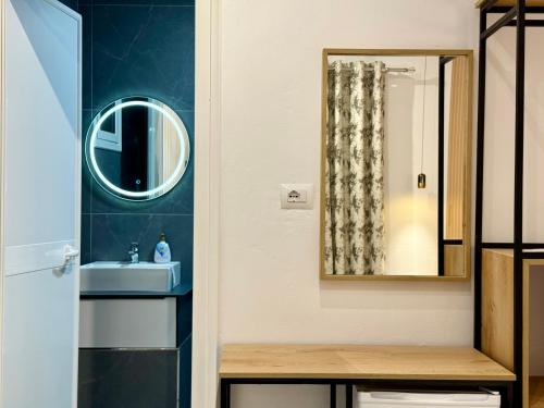 a bathroom with a sink and a mirror at Full Moon Apartments in Ksamil