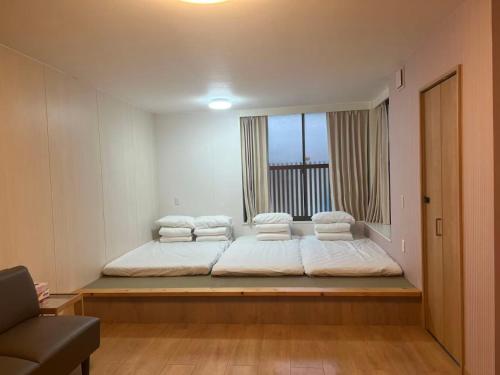a large bed in a room with a window at コテージ銚子百里 in Hasaki