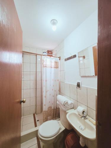 a bathroom with a toilet and a sink at Mirador All Sur Cusco in Cusco