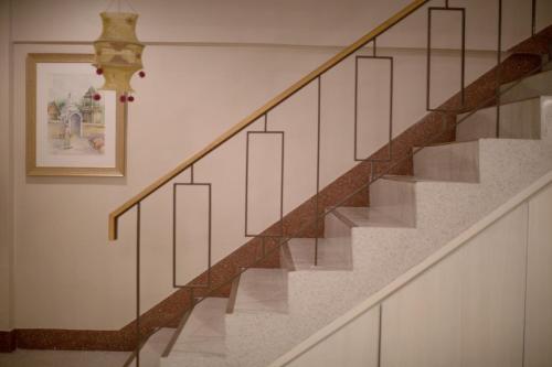a staircase with glass railings in a house at Vera Nidhra - Self check-in after 6pm in Bangkok
