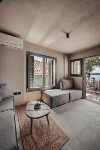 a living room with a couch and a table at EJ Boutique Suites in Milina