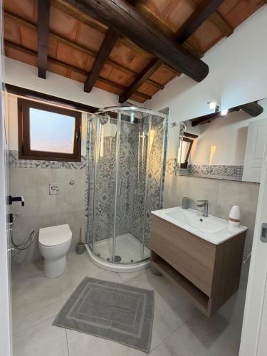 a bathroom with a shower and a toilet and a sink at Marluna in Custonaci