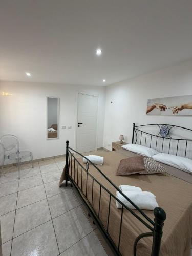 two beds in a white room with at Marluna in Custonaci