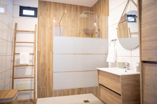 a bathroom with a shower and a sink at Cantinho FF in Santana