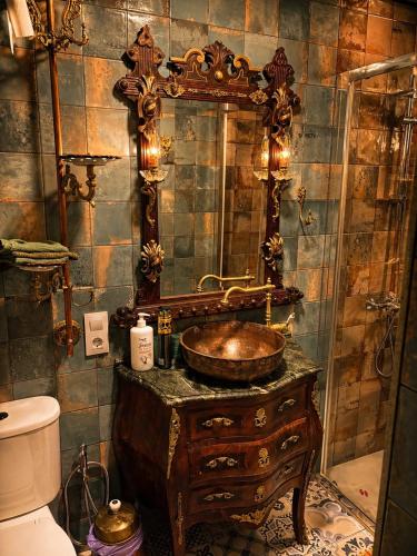 a bathroom with a wooden sink and a mirror at Luxury art Apartamenty in Pineda de Mar