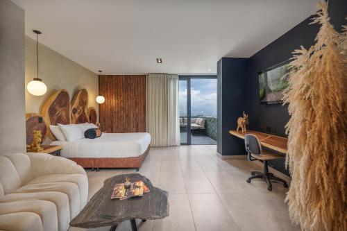a hotel room with a bed and a desk at Hotel Zelva Negra in Medellín