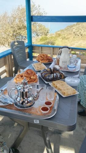a table with plates of food on a table at Casa de campo in Al Hoceïma