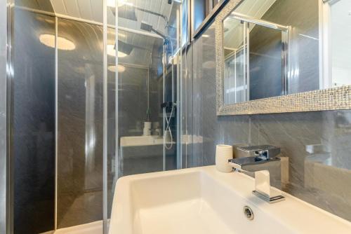 a bathroom with a sink and a glass shower at 1 Bed in Narberth oc-83862 in Whitland