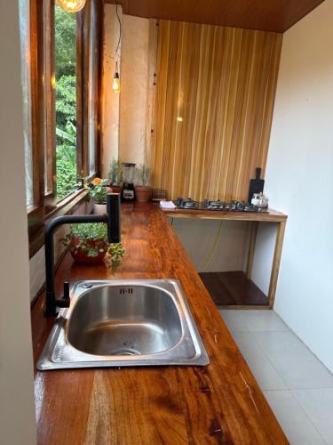 a kitchen with a sink in a wooden counter top at Villa Monarca in Ayampe