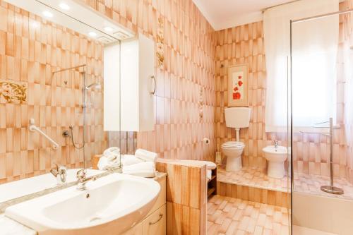 a bathroom with a sink and a toilet and a shower at Residenza Subasio Assisi in Rivotorto