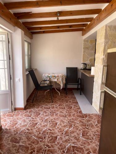 a room with a table and chairs and a stone wall at Antique villa in Guardamar del Segura