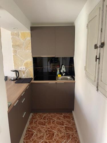 a small kitchen with a sink and a counter at Antique villa in Guardamar del Segura