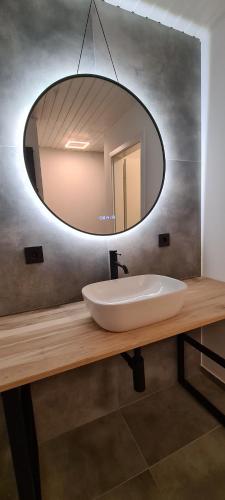 a bathroom with a sink and a mirror at Etappenziel in Rengsdorf