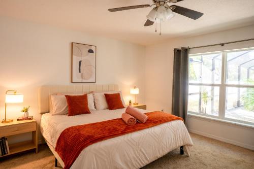 a bedroom with a bed and a ceiling fan at Villa Summerfield Swim Spa in Summerfield
