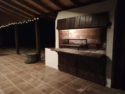 an outdoor kitchen with a stove in a patio at Colores de Yacanto in Villa Yacanto