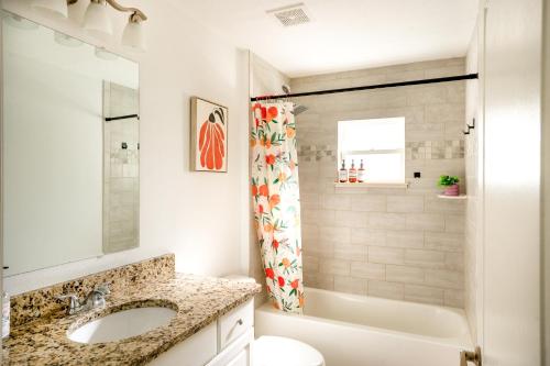 a bathroom with a sink and a tub and a toilet at Villa Summerfield Swim Spa in Summerfield
