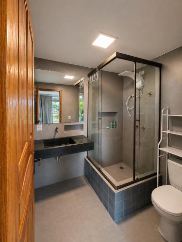 a bathroom with a shower and a sink and a toilet at Casa Luar da Sereia - Itacaré in Itacaré
