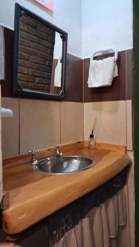 a bathroom with a sink and a mirror at BelDaMar in Capilla del Monte