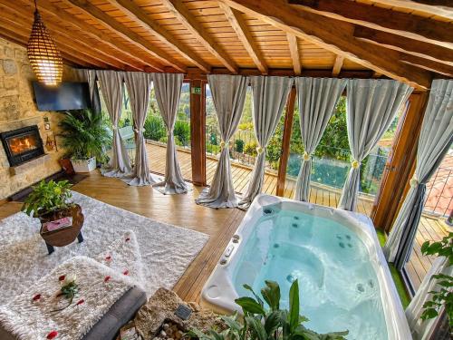 a large room with a hot tub in a house at Casa Favo de Mel - Jacuzzi & Piscina - Refúgio na Montanha in Arcos de Valdevez