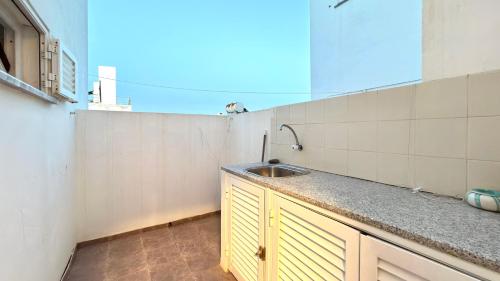 a kitchen with a sink and a counter top at Apartamento Sto Estevão in Zambujeira do Mar