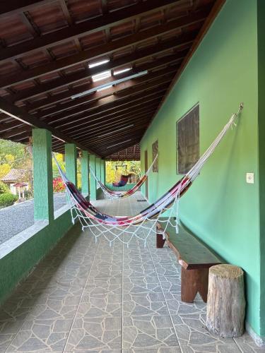 a hammock on the side of a building at Chacara el Angel in Socorro