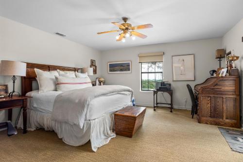 a bedroom with a bed and a ceiling fan at Pool, Porch & Stunning Views: Spacious Texas Home! in Glen Rose