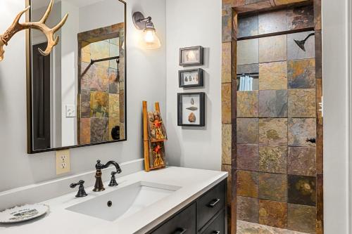a bathroom with a sink and a shower at Pool, Porch & Stunning Views: Spacious Texas Home! in Glen Rose