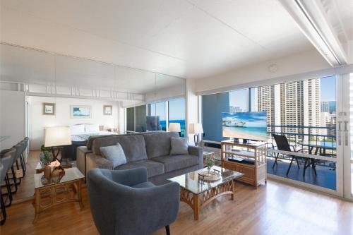 a living room with a couch and a table at Ilikai Tower 1538 condo in Honolulu