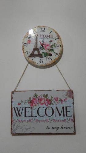 a clock with the words welcome to my home at Guest House Nise in Tbilisi City