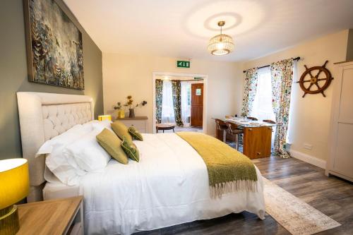 a bedroom with a white bed and a desk at The Wheelhouse, Ballycastle in Ballycastle