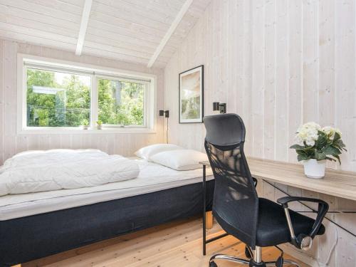 a bedroom with a bed and a desk and a chair at 6 person holiday home in Juelsminde-By Traum in Sønderby