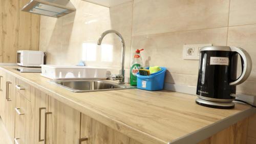 a kitchen counter with a coffee maker on it at Sleeping portomarin 1 in Portomarin