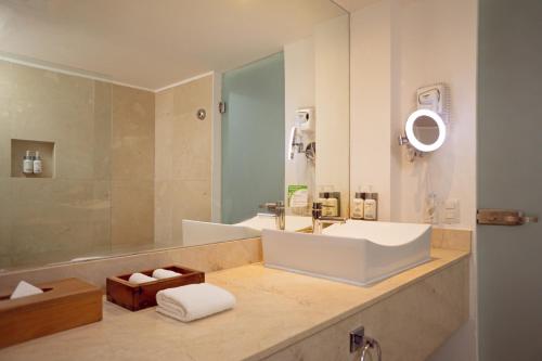 a bathroom with a white sink and a shower at Flamingo Cancun All Inclusive in Cancún