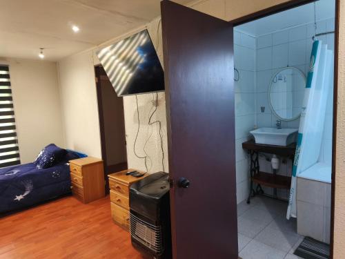 a room with a bathroom with a sink and a mirror at Hostal Fernanda in Santa Cruz