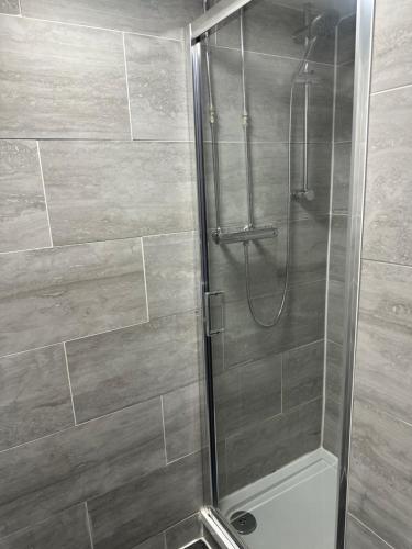 a shower with a glass door in a bathroom at Park hotel in Bradford