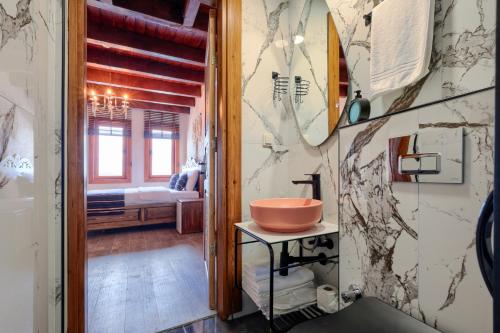 a bathroom with a sink on a table with a mirror at Kilitbahir Kale Konak in Eceabat