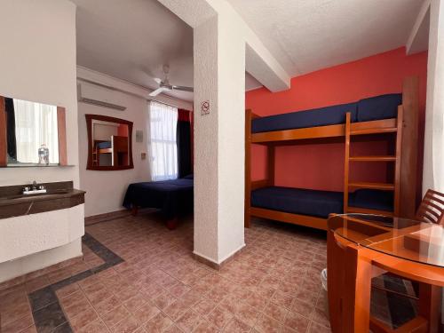 a room with two bunk beds and a table at Hotel Soberanis in Cancún