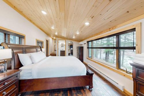 a bedroom with a bed and a large window at River House in North Creek