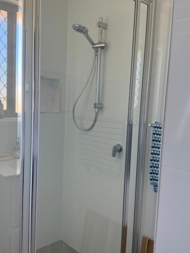 a shower with a shower head in a bathroom at Relax on Ross in Inverell