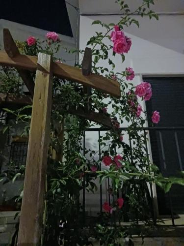 a wooden fence with pink flowers on it at Flamingo's Bay in Corroios
