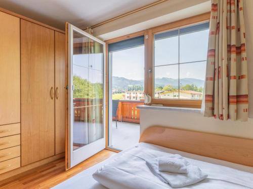 a bedroom with a bed and a large window at Haus am Bad in Bad Häring