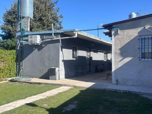 a white building with a porch and a patio at Casa May - A 15 min del Aeropuerto in Barrio Esteban Echeverría