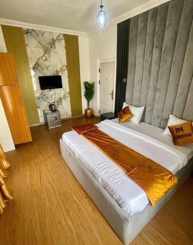 a bedroom with a large bed in a room at Montevar Hotel in Benin City