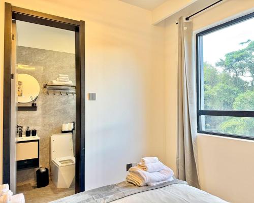 a bathroom with a toilet and a sink and a mirror at Neptune Luxe in Nairobi
