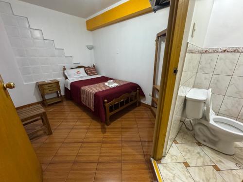 a small room with a bed and a toilet at Lhotse Hostel B&B in Huaraz