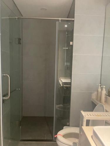 a bathroom with a glass shower with a toilet at Canary Nest Solforest Ecopark Homestay in Kim Quan