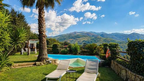 a villa with a pool and mountains in the background at Casa Favo de Mel - Jacuzzi & Piscina - Refúgio na Montanha in Arcos de Valdevez