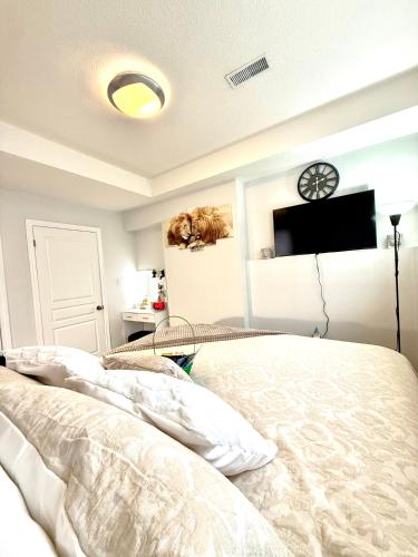 a bedroom with a bed and a tv on the wall at Room in niagara falls Pluto studio in Niagara Falls