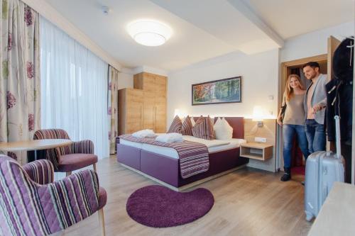 A bed or beds in a room at Wellnesshotel Aumühle