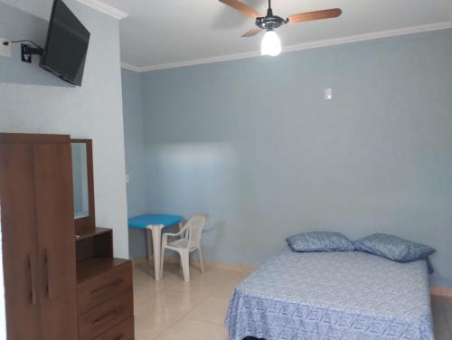 a bedroom with a bed and a flat screen tv at Pousada sushi-lazer in Casa Branca